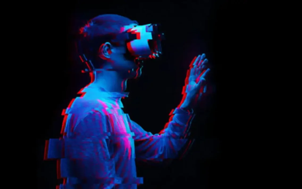 A person wearing a VR headset in a dark USC Mixed Reality Lab image.